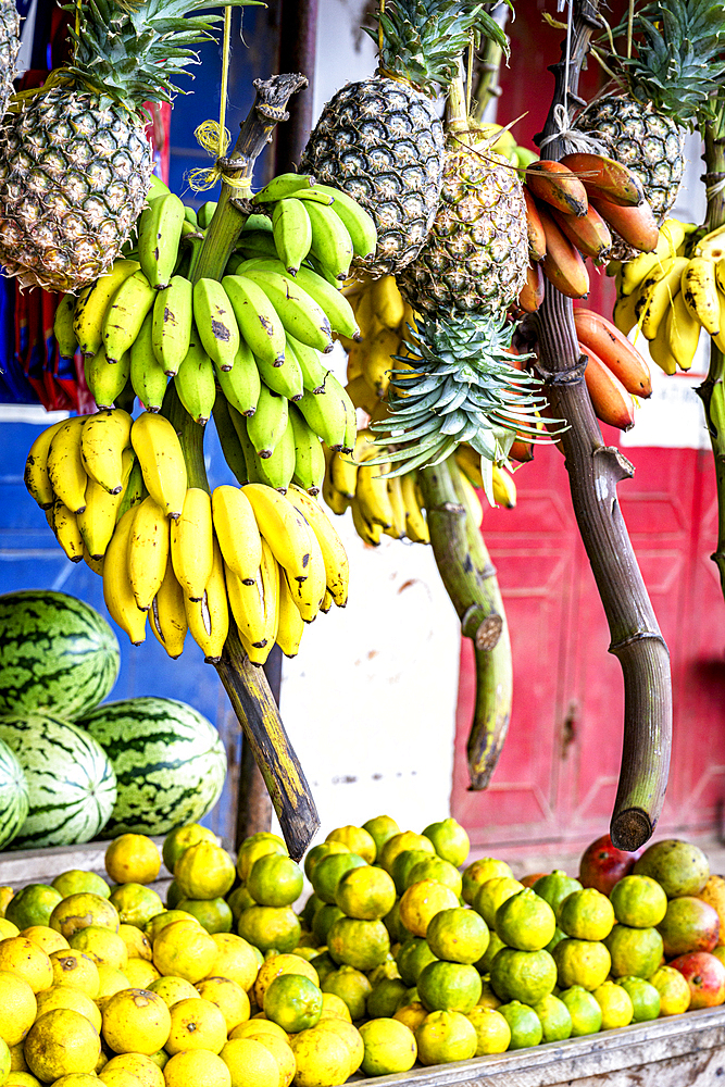 Exotic fruit hanging outdoors in a local shop, Zanzibar, Tanzania, East Africa, Africa