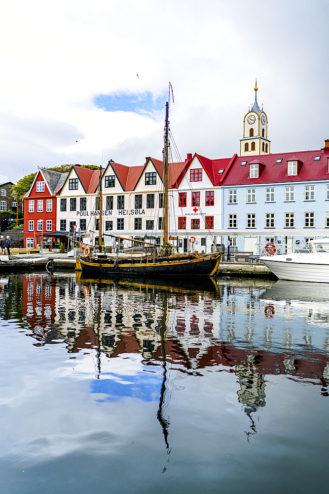 Ancient buildings and ship moored in the harbor of Torshavn, Streymoy Island, Faroe Islands, Denmark, Europe