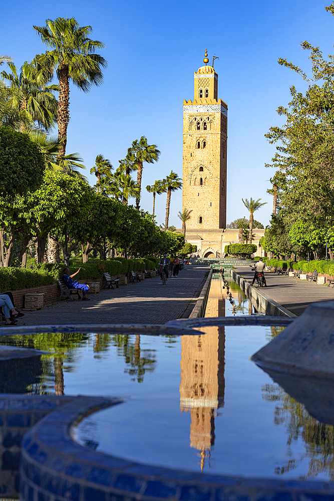 Ancient minaret tower of Koutoubia Mosque, UNESCO World Heritage Site, reflected in a fountain in the formal gardens, Marrakech, Morocco, North Africa, Africa