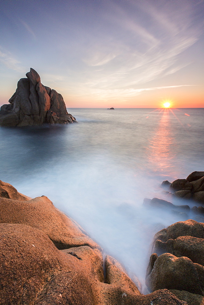 The sun setting behind the rocks of the peninsula of Capo Testa, by Santa Teresa di Gallura, Sardinia, Italy, Mediterranean, Europe