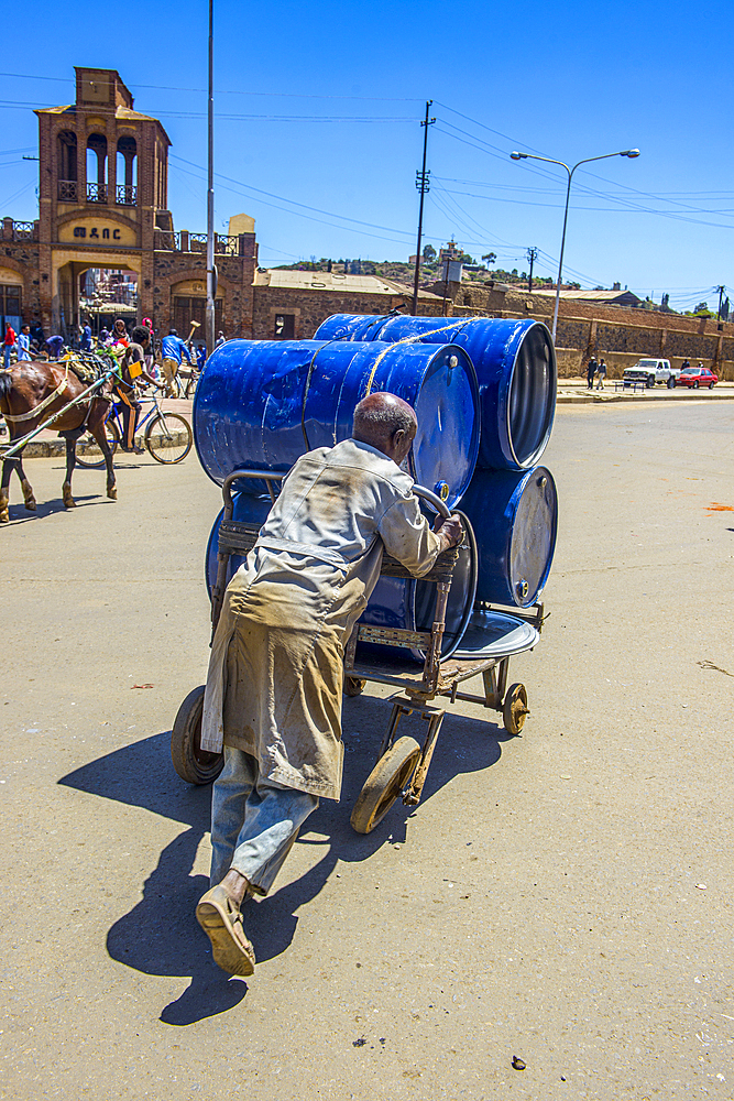 Man pushing barrels to the Medebar market, Asmara, Eritrea, Africa