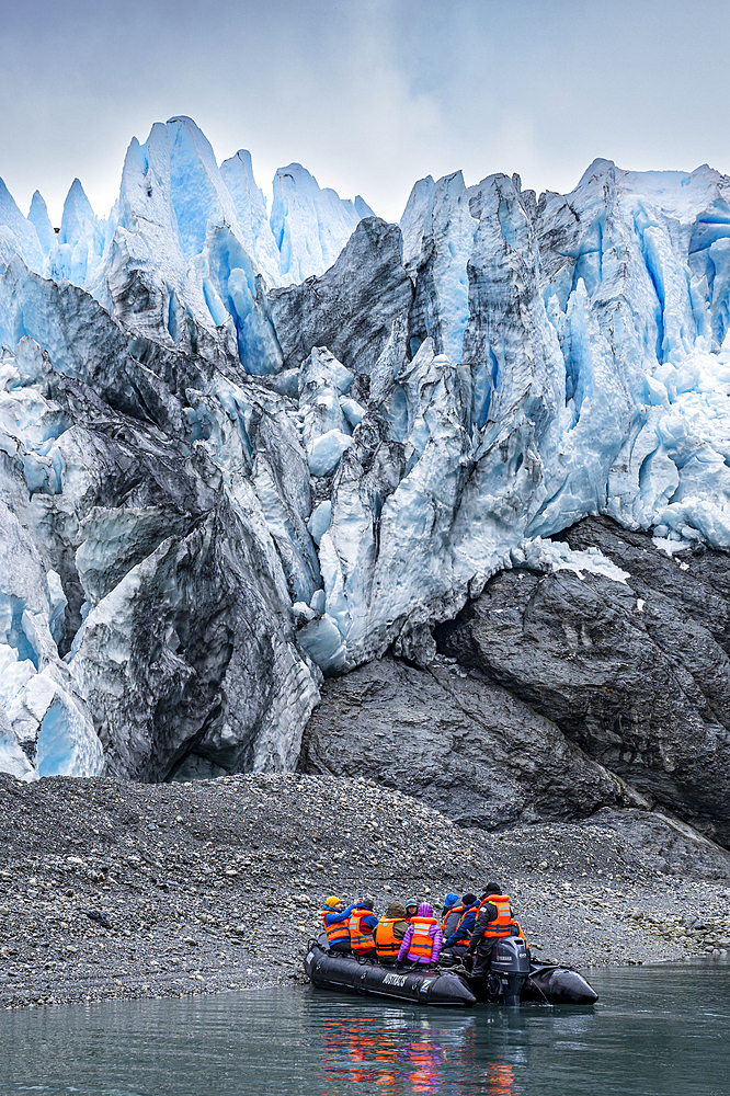 Tourists in Zodiac below the Aguila glacier, Tierra del Fuego, Chile, South America