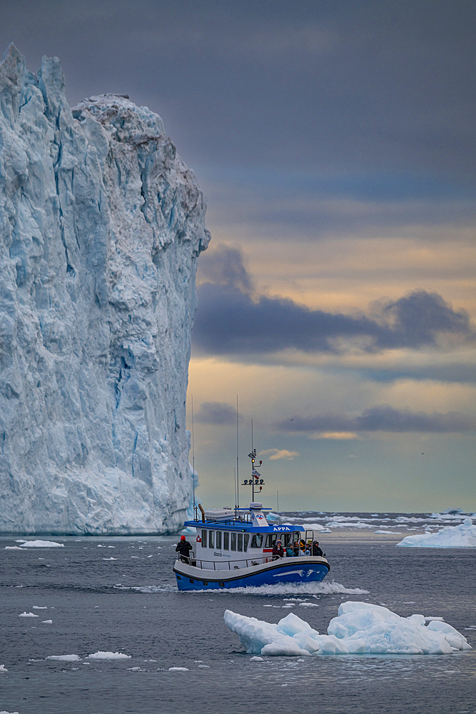 Little boat between the icebergs of the Ilulissat Icefjord, UNESCO World Heritage Site, Western Greenland, Denmark, Polar Regions