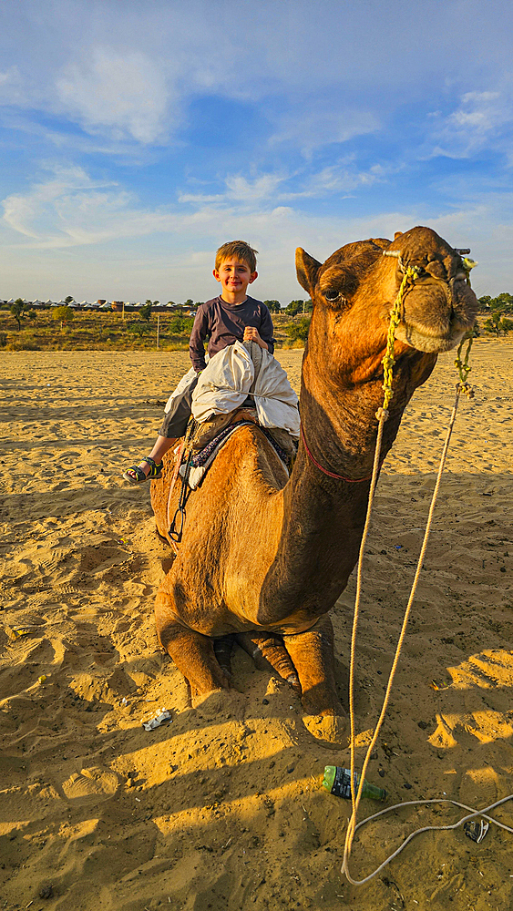 Family riding on camels, Desert camp, Osian, India