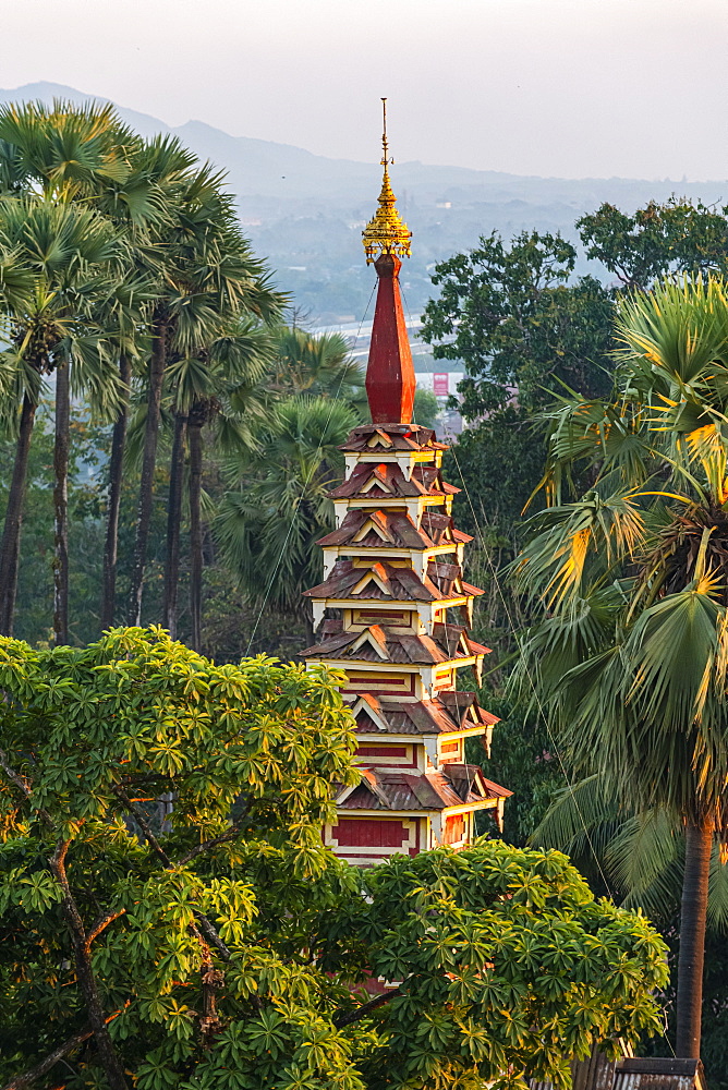 Top of a pagoda rises out of the forest, Kyaikthanian paya, Mawlamyine, Mon state, Myanmar (Burma), Asia