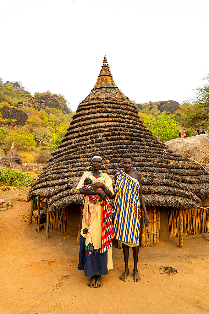 Traditional dressed young girls from the Laarim tribe in front of their hut, Boya Hills, Eastern Equatoria, South Sudan, Africa