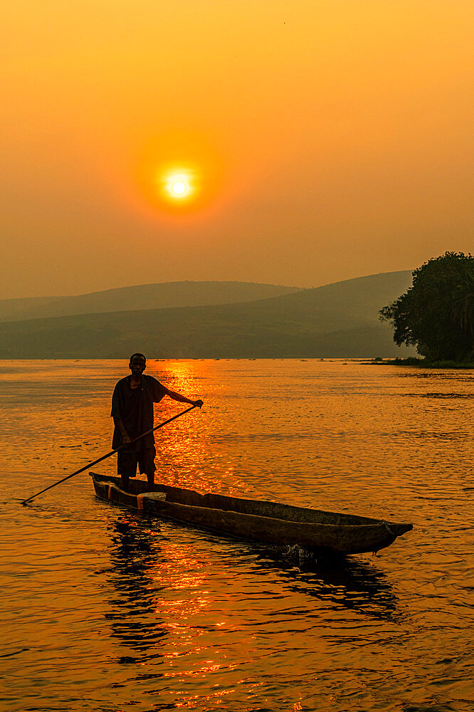 Man on his dugout canoe at sunset on the Congo River, Democratic Republic of the Congo, Africa