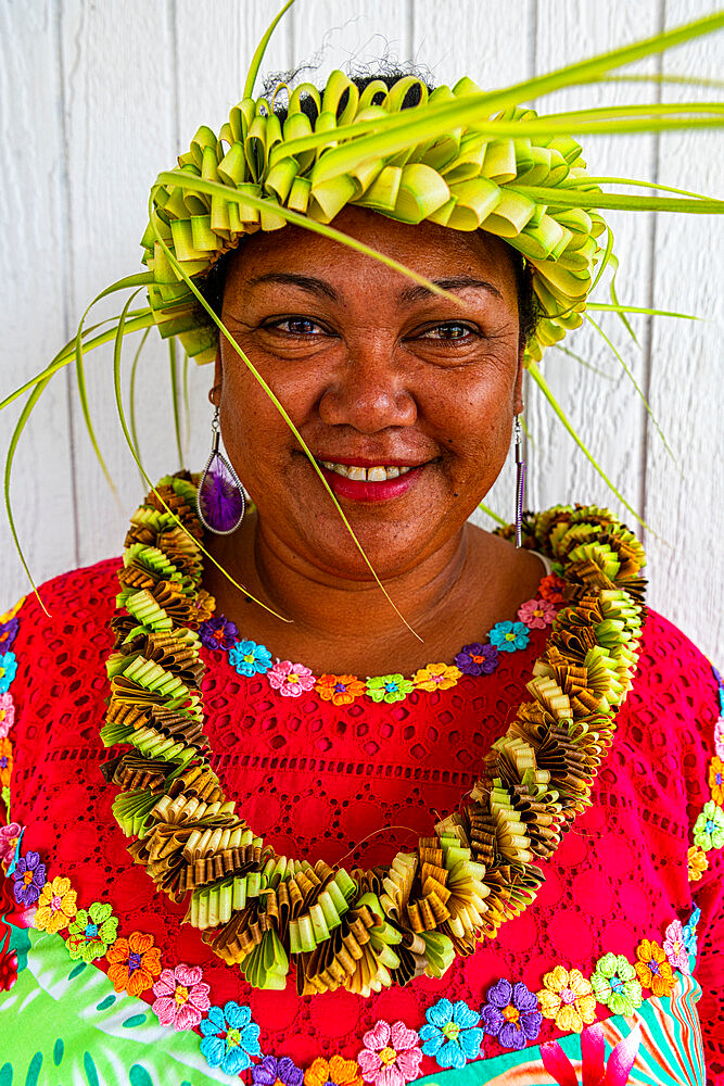 Colourful dressed woman with woven leaf band on her head, Hikueru, Tuamotu archipelago, French Polynesia, South Pacific, Pacific