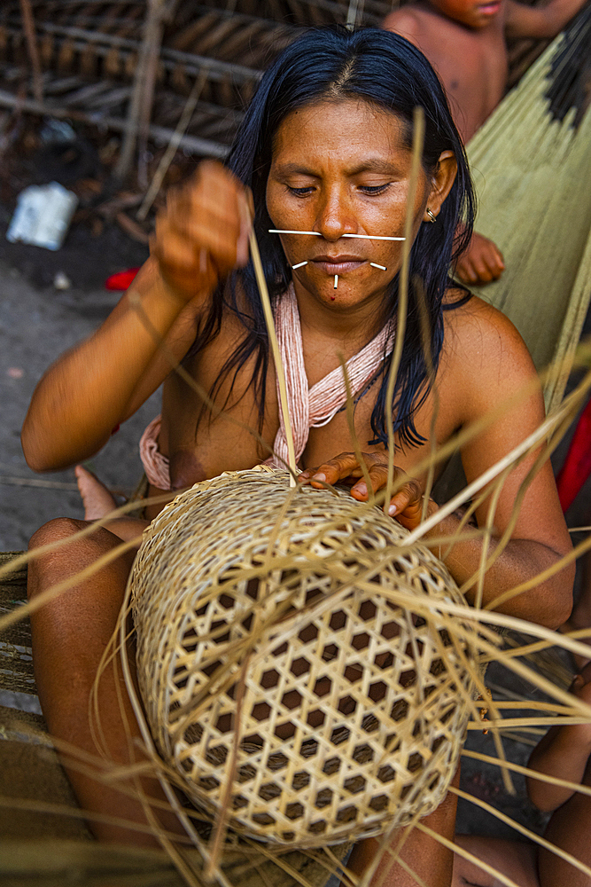 Woman from the Yanomami tribe weaving a basket, southern Venezuela, South America