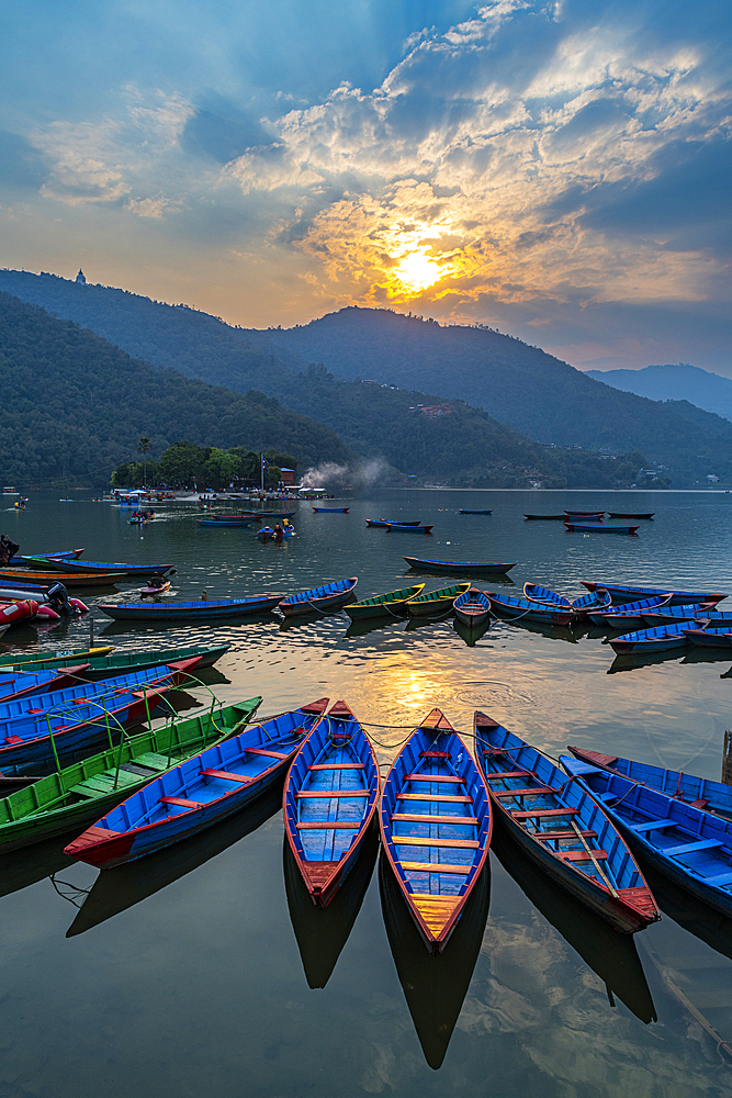 Sunset over Fewa Lake with many rowing boats, Pokhara, Nepal, Asia