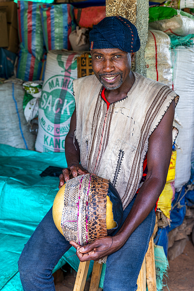 Man creating a snake hat, traditional medicine market, Garoua, Northern Cameroon, Africa