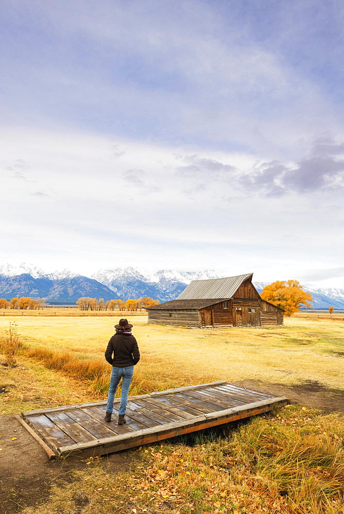 Woman at Mormon Row and Teton Range, Grand Teton National Park, Wyoming, United States of America, North America