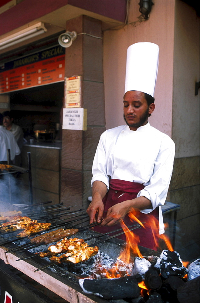 Street kitchen, pakistan. Islamabad. Roasting chicken at a food stall