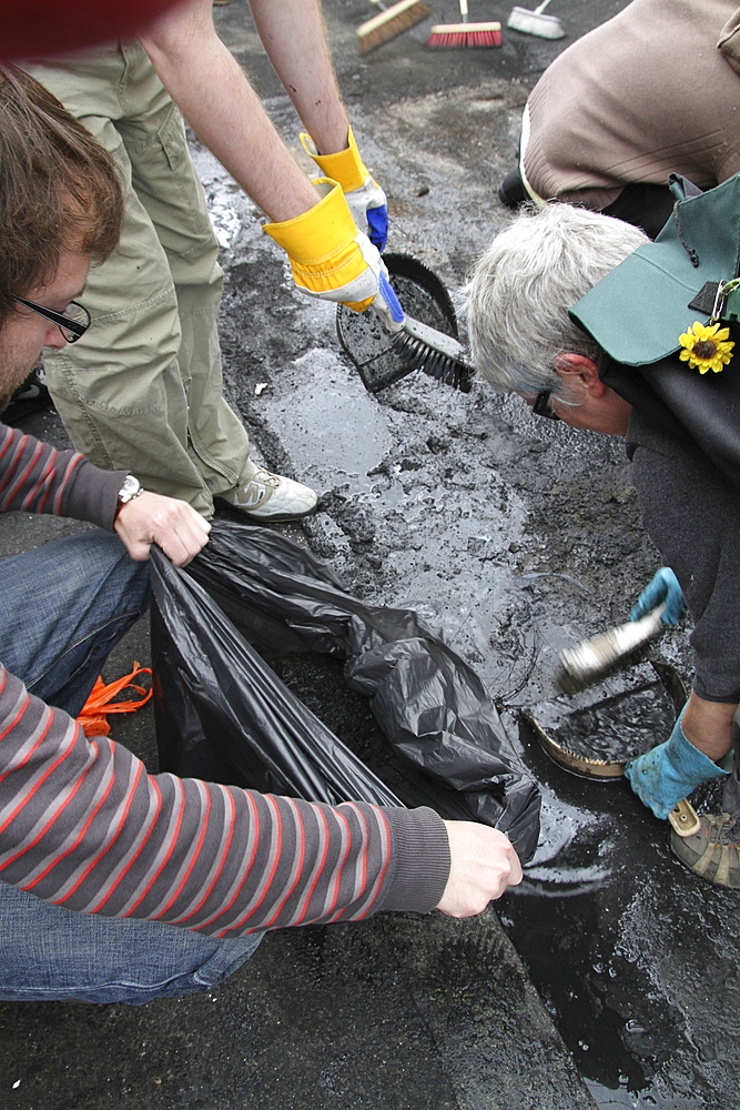 Local community get together to clear damage caused by rioters in Hackney, London, UK ;