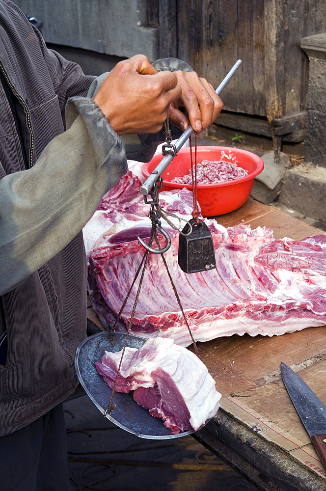 China vendors selling meat at the market place in a village in yunnan province