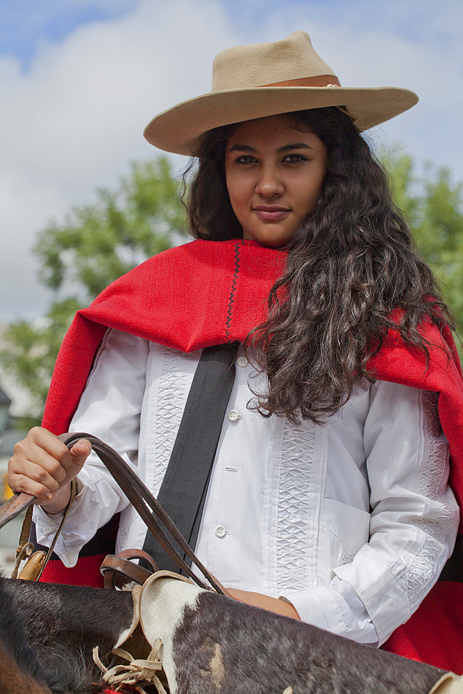 Woman in a parade of gauchos in traditional costumes in Salta, Argentina,South America