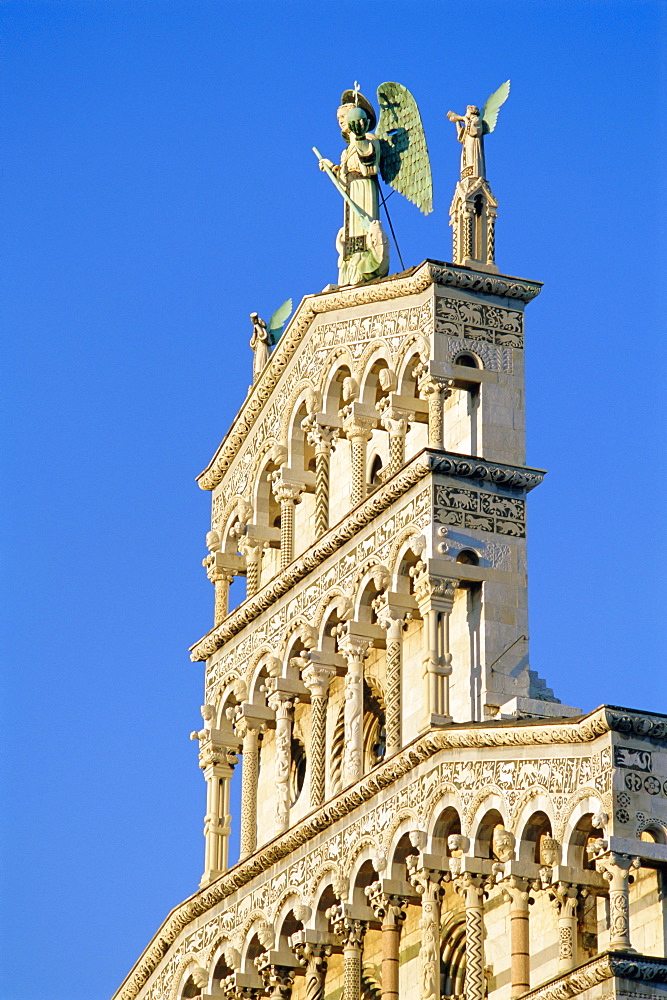 Upper loggias, West front of San Michele (crowned by archangel statue), Lucca, Tuscany, Italy