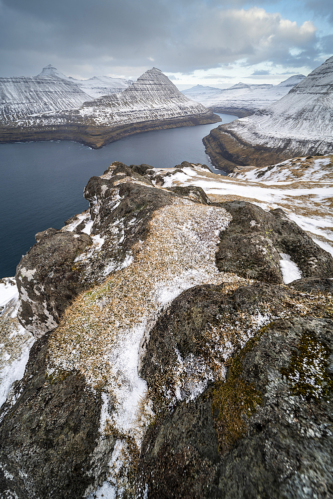 Fjord view and snow covered rocks and mountains, Funningur, Esturoy Island, Faroe Islands, Denmark, Europe