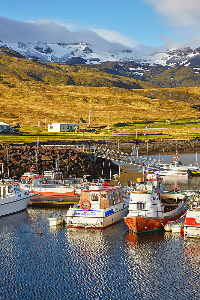 Fishing boats in the harbour at Grundarfjordur, with a mountainous backdrop, on the Snaefellsnes peninsula, west Iceland, Polar Regions