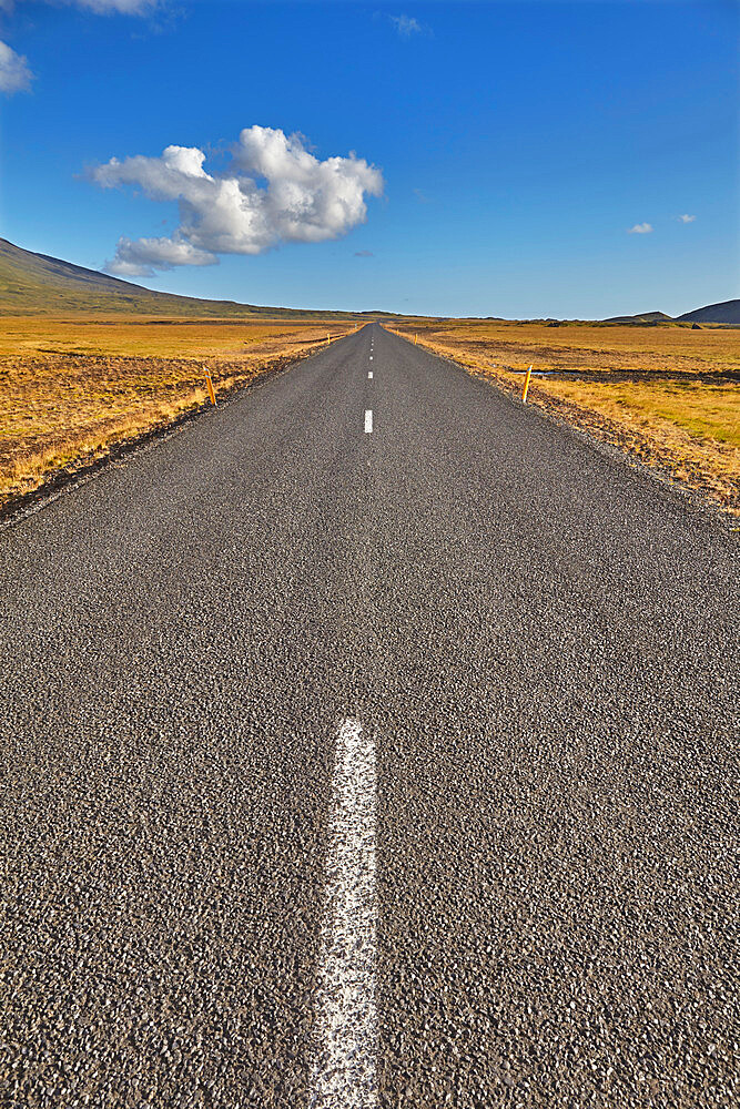 An arrow-straight road cuts across a lava field in Snaefellsjokull National Park, Snaefellsness peninsula, western Iceland, Polar Regions