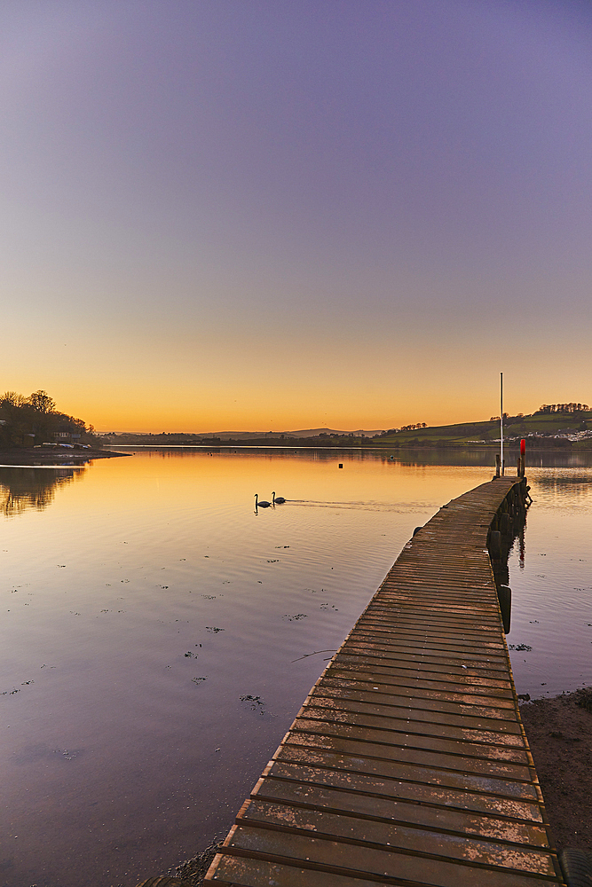 A very calm dusk scene, with a wooden jetty on the estuary of the River Teign, at Coombe Cellars, near Newton Abbot, south coast of Devon, England, United Kingdom, Europe