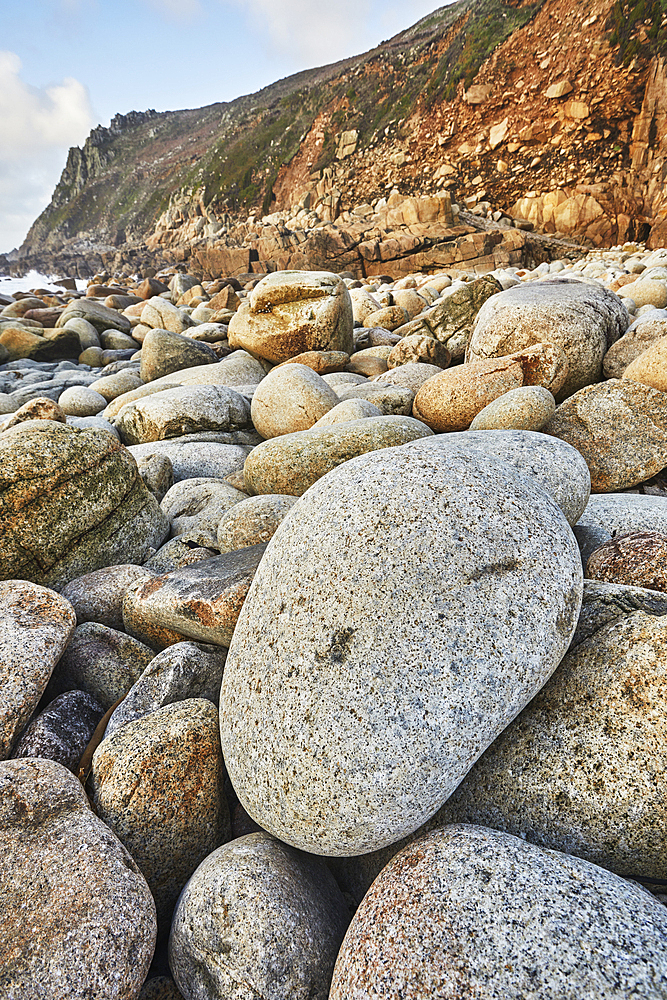 Granite boulders strewn across the shore at Porth Nanven, at the end of Cot Valley, near St. Just, Atlantic coast of the far west of Cornwall, England, United Kingdom, Europe