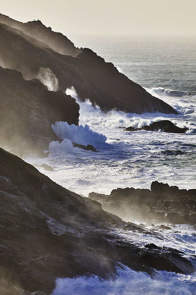 Atlantic cliffs pounded by surf and spray during stormy winter weather, at Pendeen, near S.t Just, in the far west of Cornwall, England, United Kingdom, Europe