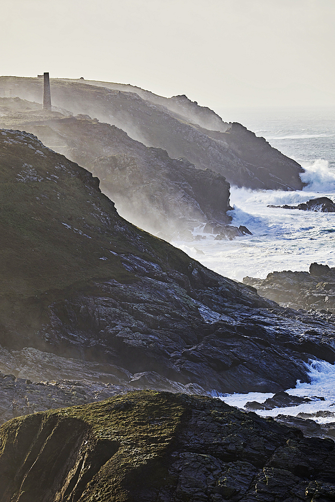 Atlantic cliffs pounded by surf in stormy winter weather, at Pendeen, with the ruins of old tin mines, part of the UNESCO World Heritage Site Cornwall and West Devon Mining Landscape, near St. Just, Cornwall, England, United Kingdom, Europe