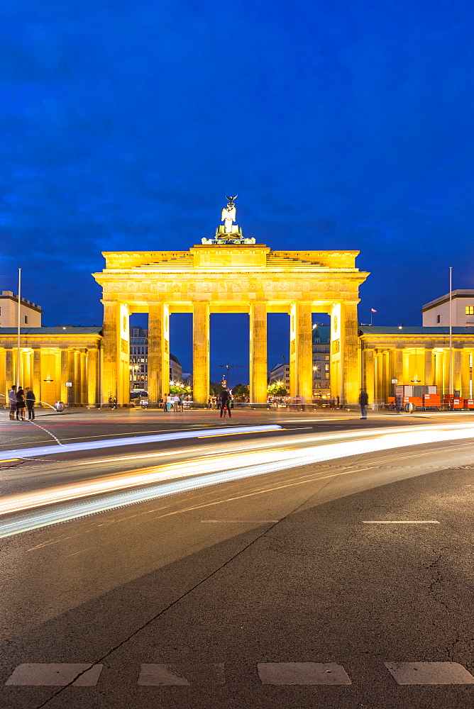 Light trails by Brandenburg Gate at night in Berlin, Germany, Europe