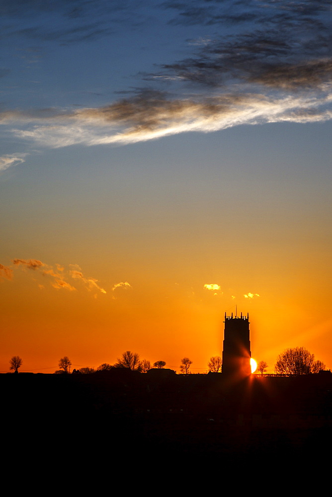 Sunset behind the Parish Church of the Holy Trinity and All Saints at Winterton on Sea, Norfolk, England, United Kingdom, Europe