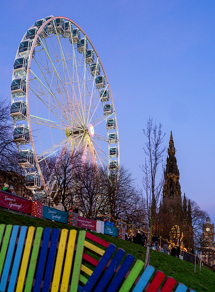 Ferris Wheel with Sir Walter Scott Monument in the background, Christmas time in Edinburgh, Scotland, UK