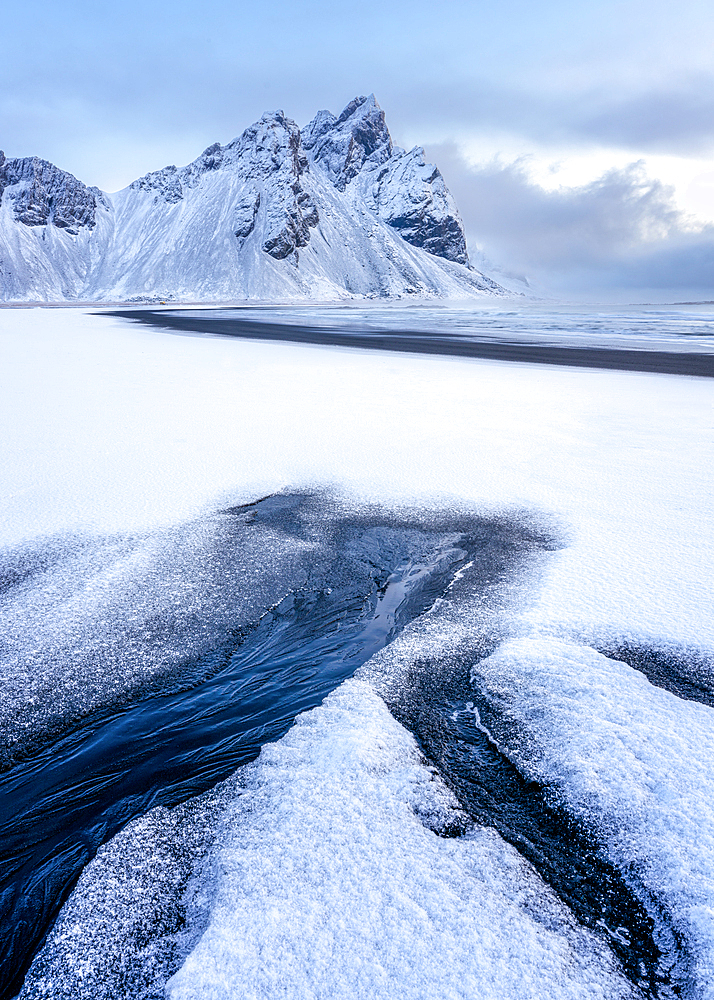 View of the mountains of Vestrahorn from black volcanic sand beach after snowfall, Stokksnes, South Iceland, Iceland, Polar Regions