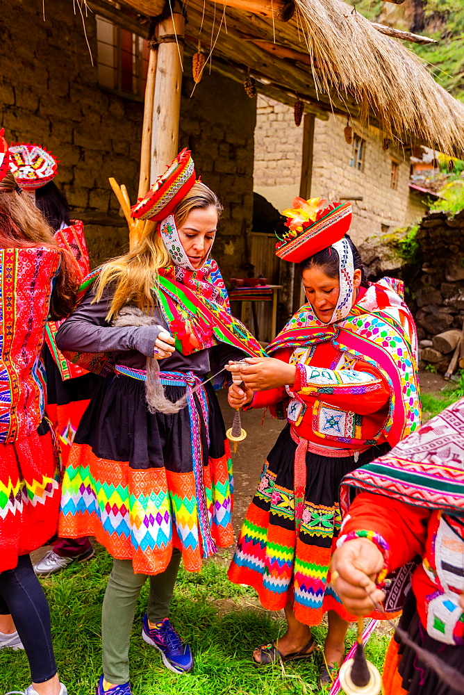 Visitors learning how to weave from the Huilloc weavers, Peru, South America