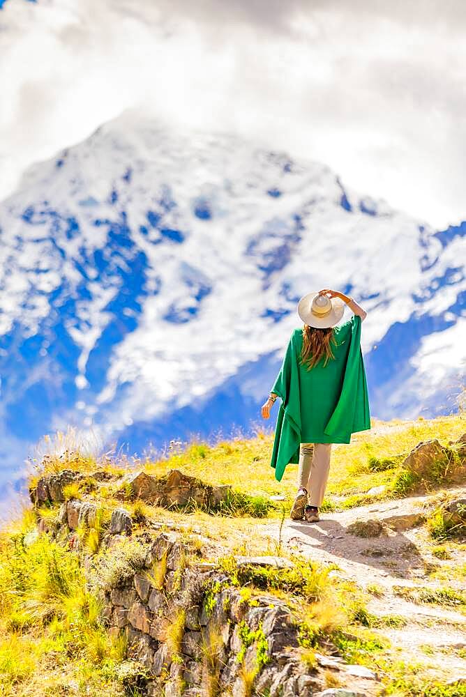 Woman enjoying the view high in the Andes Mountains while exploring Inti Punku (Sun Gate), Cusco, Peru, South America