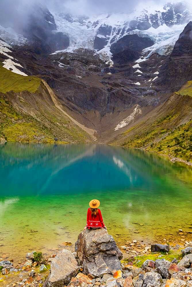 Woman enjoying the view of crystal clear Humantay Lake, Cusco, Peru, South America