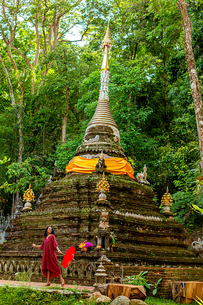 Woman with umbrella at Wat Pha Lat, Chiang Mai, Thailand, Southeast Asia, Asia