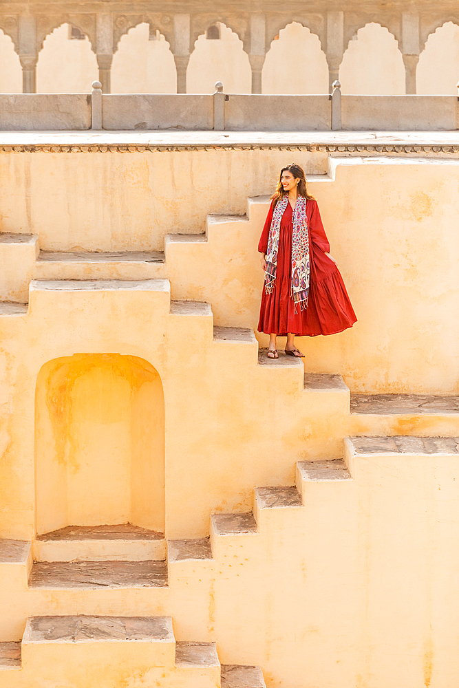 Woman in red garment at Panna Meena ka Kund, Jaipur, Rajasthan, India, Asia