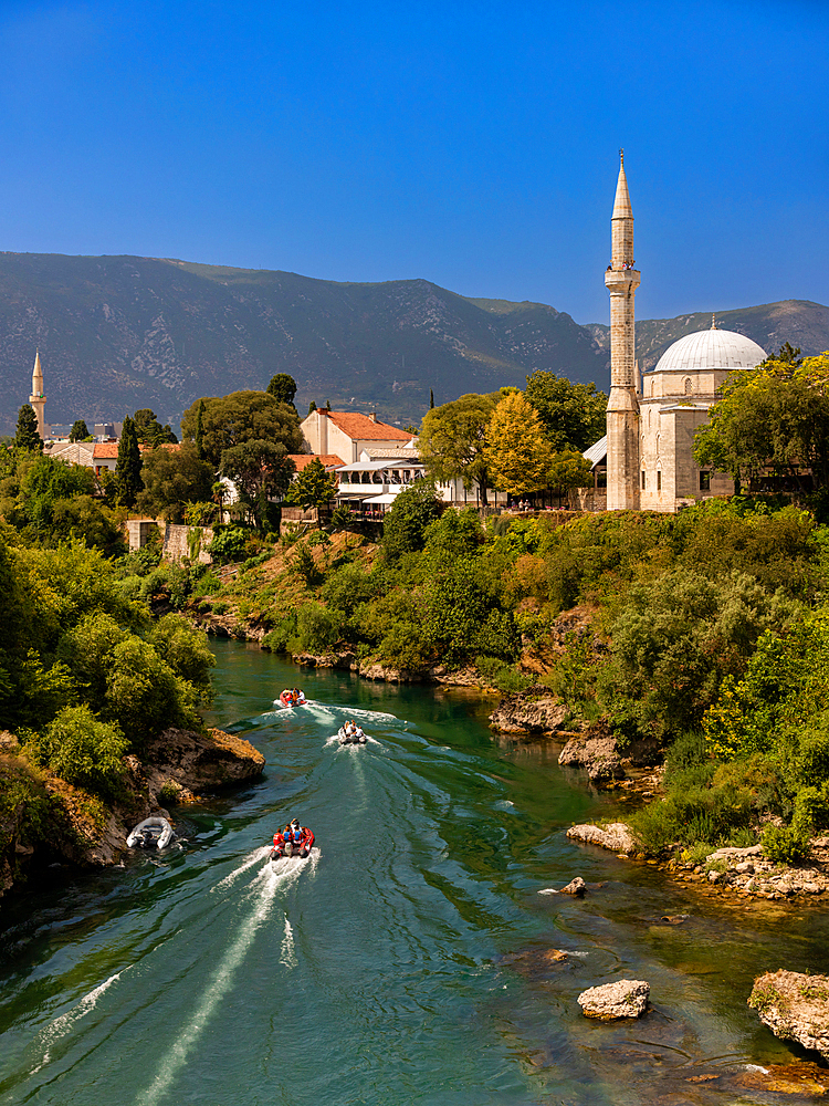 Boats on the Neretva River cutting through Mostar, Bosnia and Herzegovina, Europe