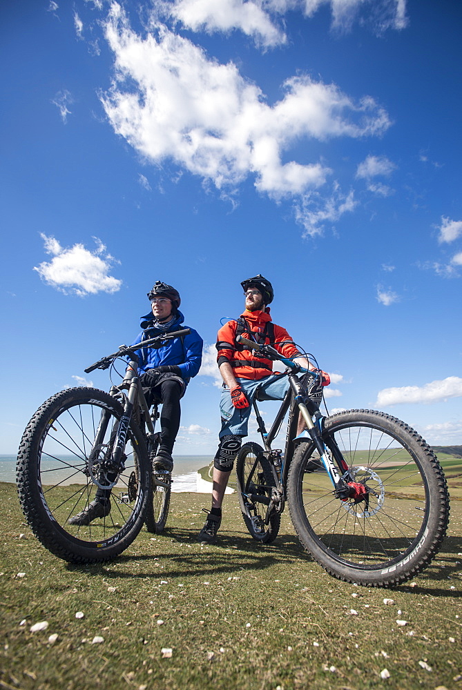 Mountain biking along the chalk cliffs coastal path on the South Downs Way near Beachy Head, South Downs National Park, East Sussex, England, United Kingdom, Europe