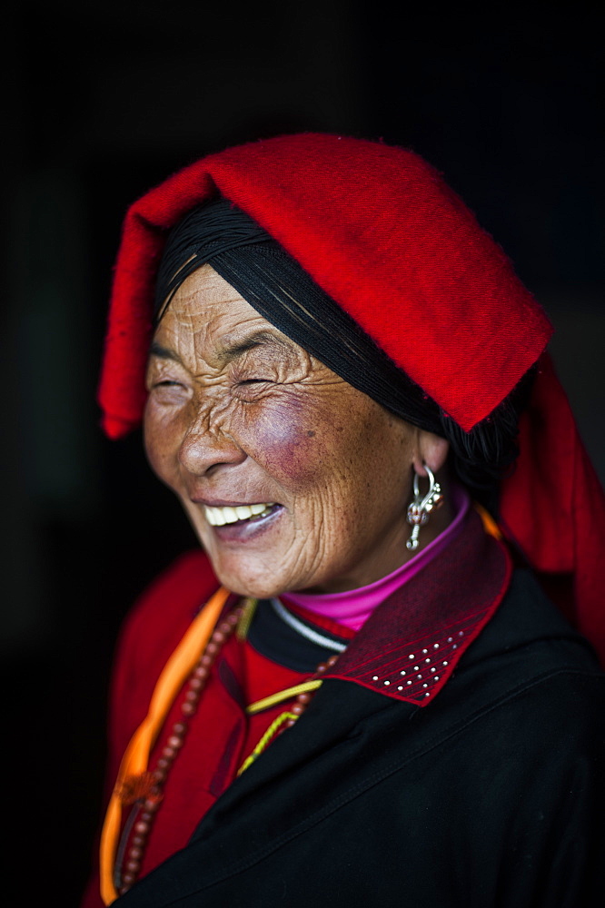 An Chinese Ngawa woman wearing traditionally bright dress in Songpa, Sichuan, China, Asia