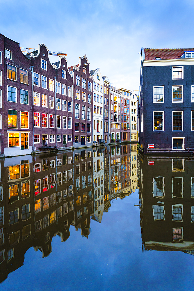 Old gabled buildings by a canal at dusk, Oudezijds Kolk, Amsterdam, North Holland, The Netherlands, Europe