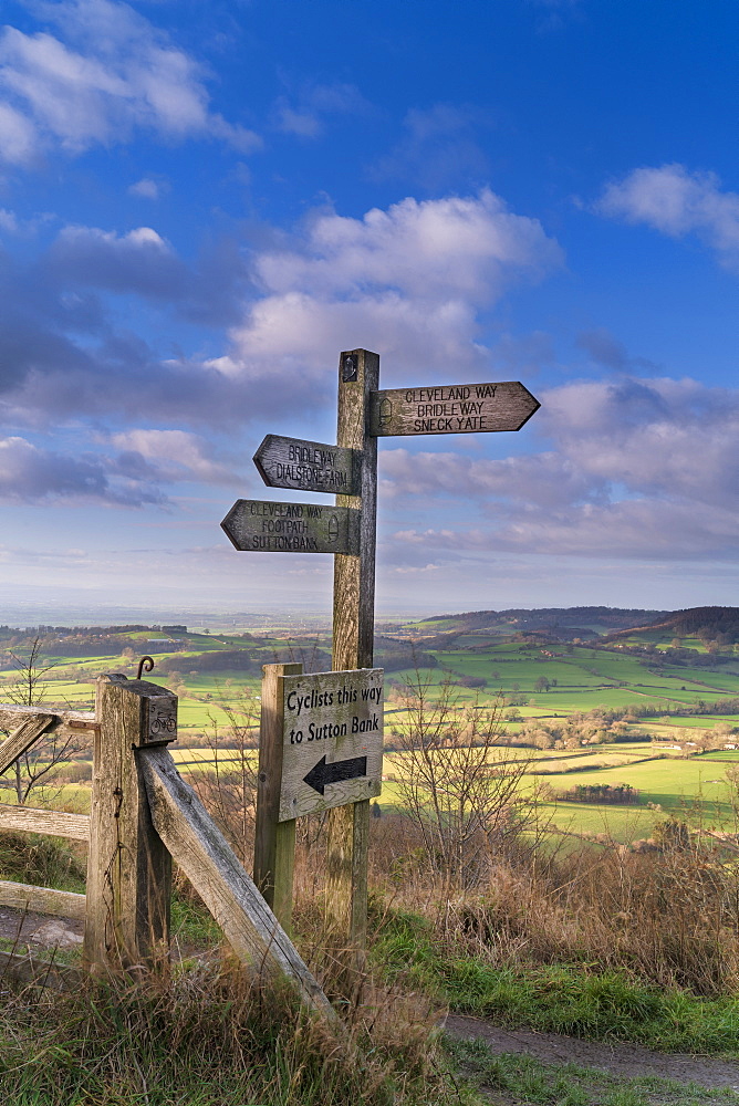 Signpost and distant view of the Vale of York from Whitestone Cliff, North Yorkshire Moors, Yorkshire, England, United Kingdom, Europe