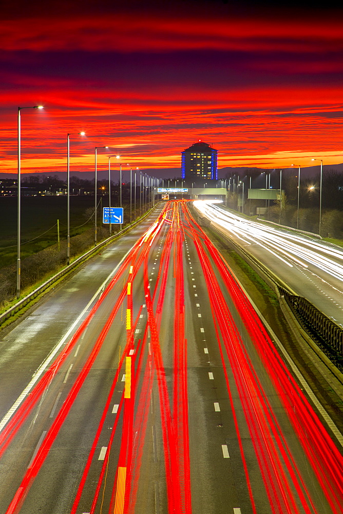 Red sky sunset, traffic light trails, M8 Motorway, Scotland, United Kingdom, Europe