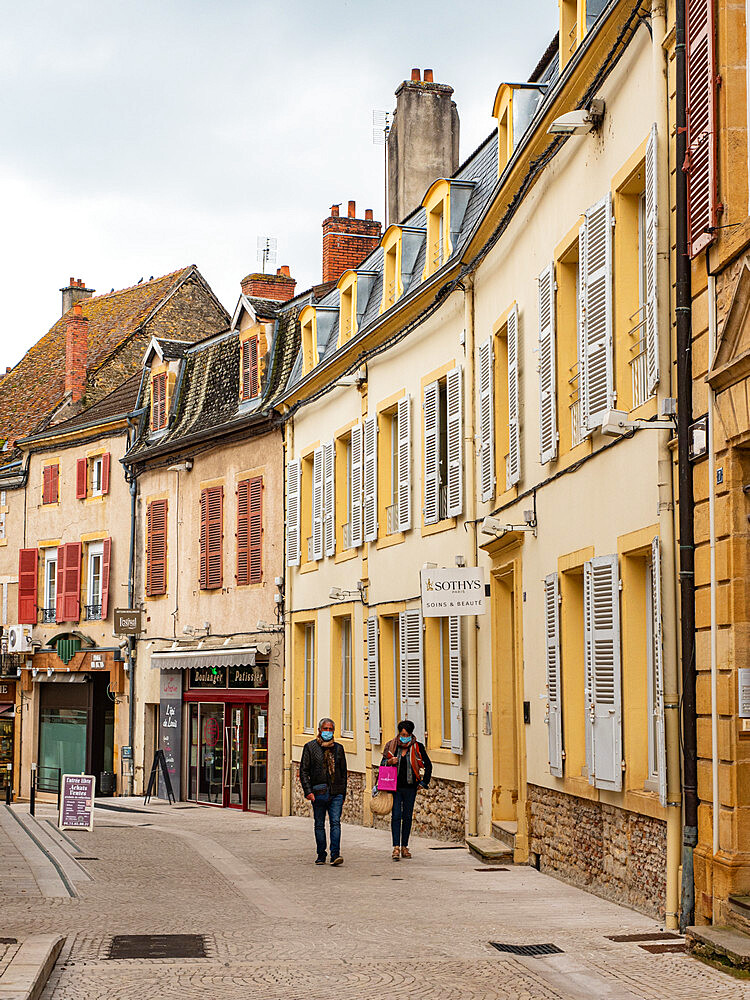 Walkers on a small-town street in southern Burgundy, Burgundy, France, Europe