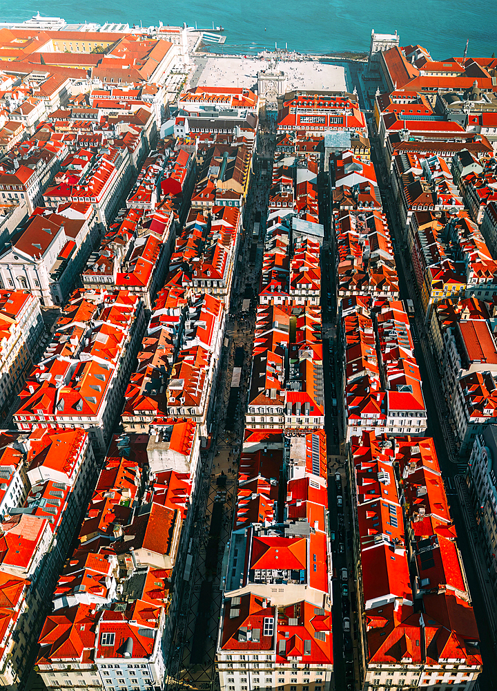 Aerial vertical drone perspective of the Baixa district with its iconic grid system leading to the Commerce Square and Tagus River, Lisbon, Portugal, Europe