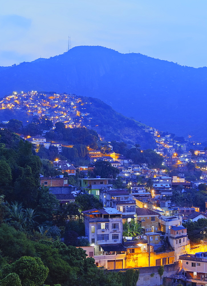 Twilight view of the favelas Unidos de Santa Teresa Morro do Escondidinho and Morro dos Prazeres, Rio de Janeiro, Brazil, South America