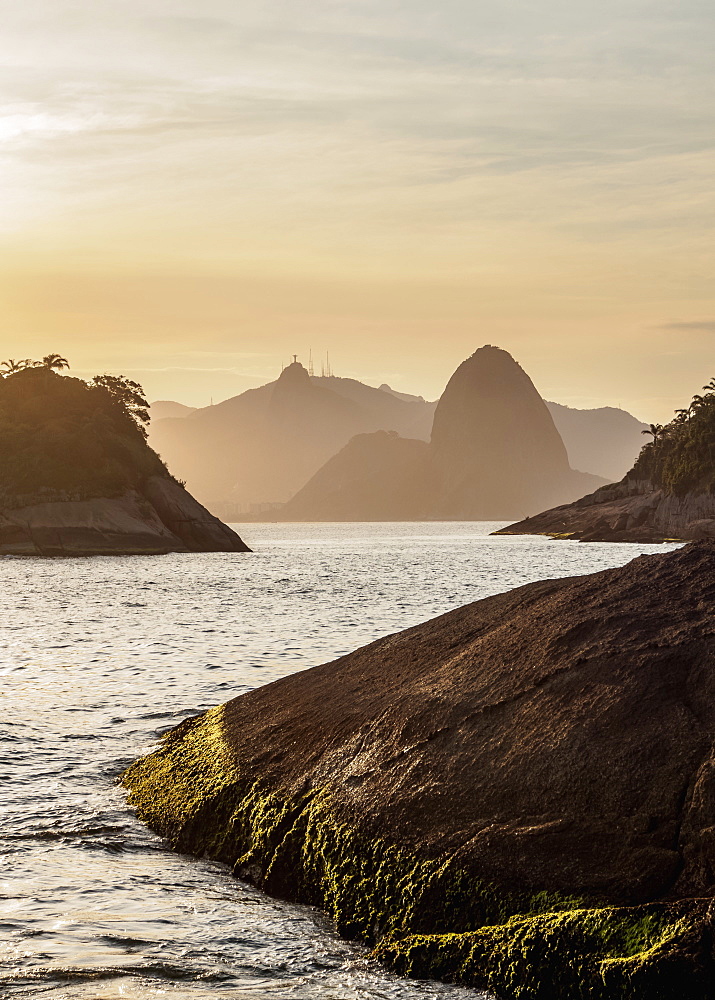 View over rocks of Piratininga towards Rio de Janeiro, sunset, Niteroi, State of Rio de Janeiro, Brazil, South America