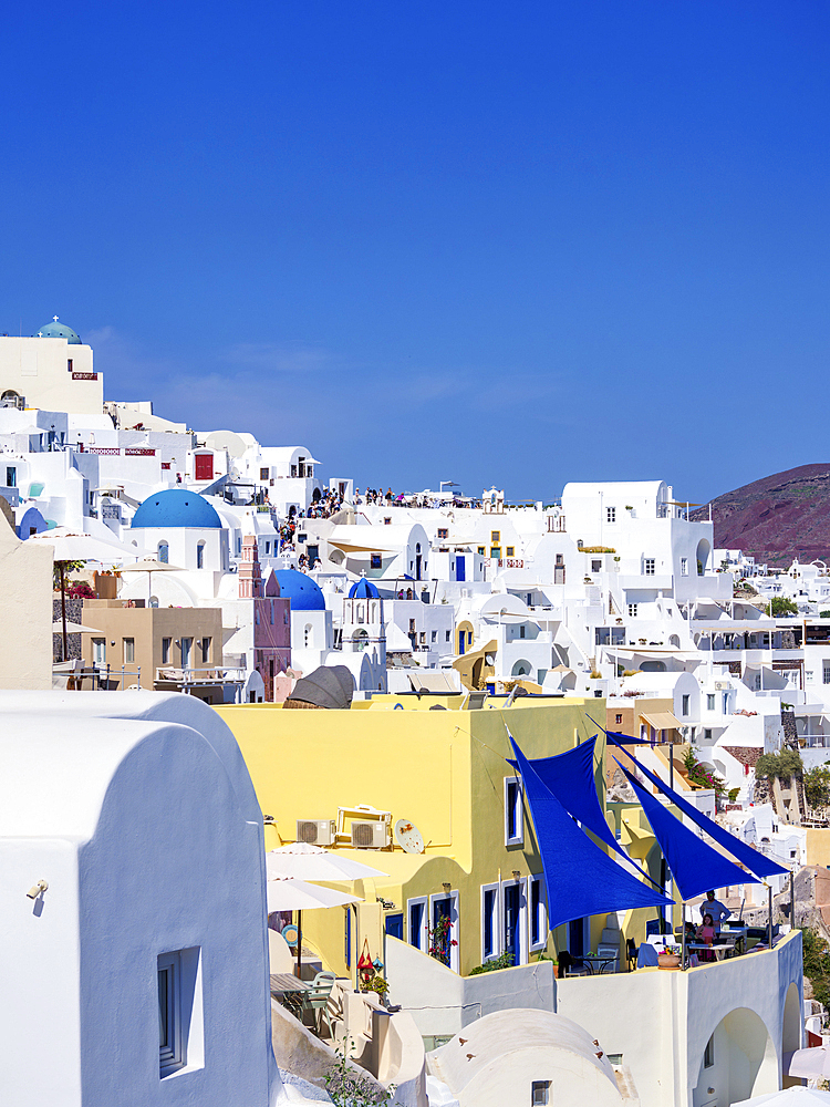 View towards the blue domed churches of Resurrection of the Lord and Saint Spyridon, Oia Village, Santorini (Thira) Island, Cyclades, Greek Islands, Greece, Europe