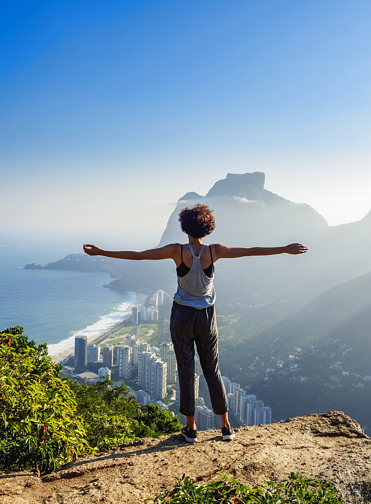 Brazilian girl looking towards the Pedra da Gavea and Sao Conrado from Dois Irmaos Mountain, Rio de Janeiro, Brazil, South America