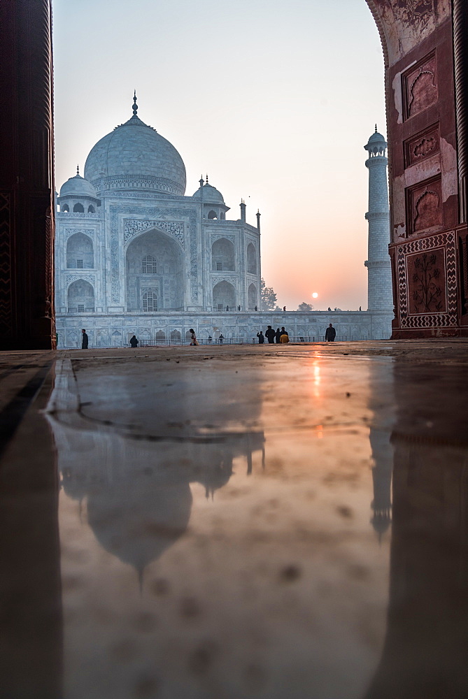 Reflections as the sun rises behind the Taj Mahal, UNESCO World Heritage Site, Agra, Uttar Pradesh, India, Asia